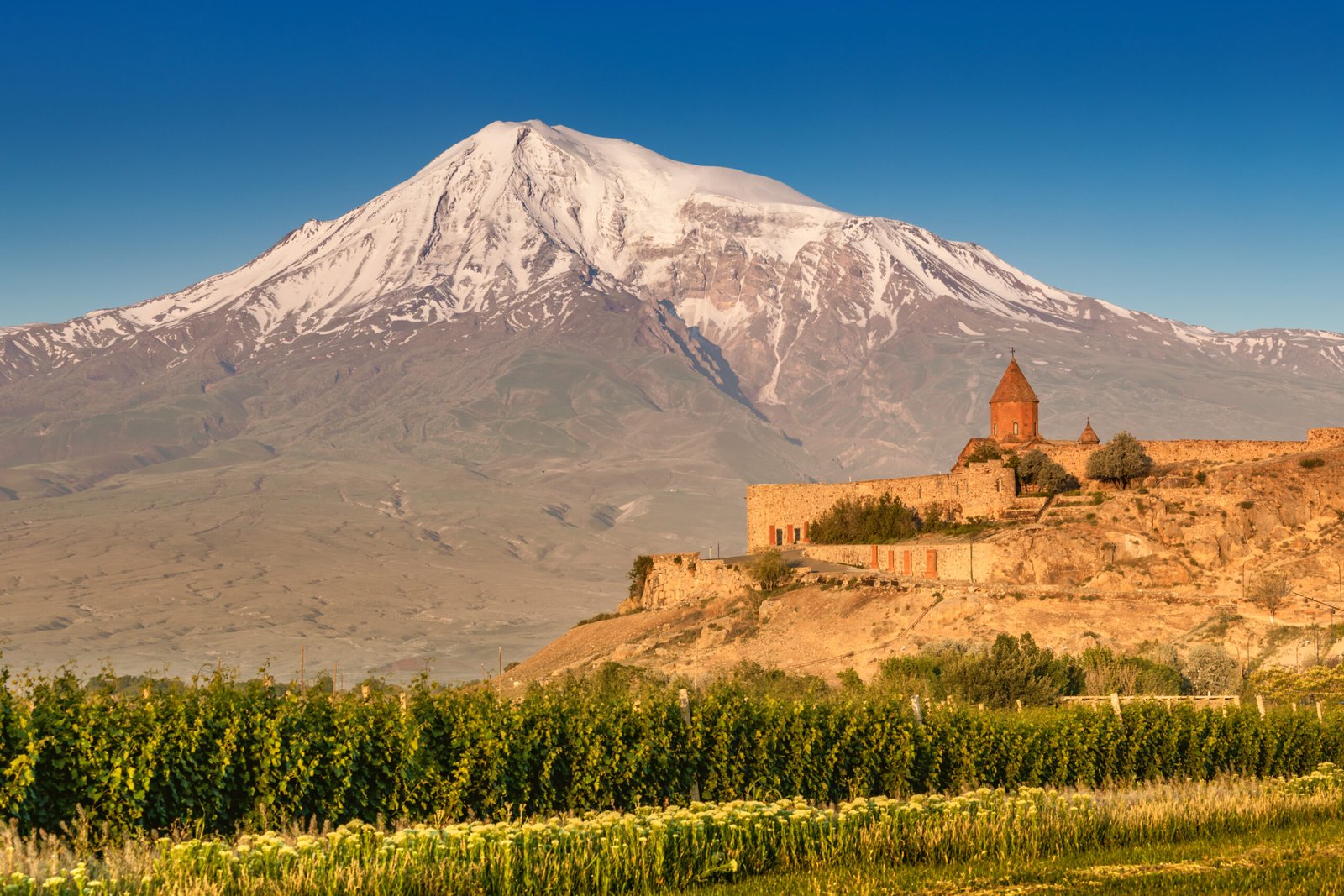 Khor Virap Monastery in Armenia with Mount Ararat glowing at sunrise